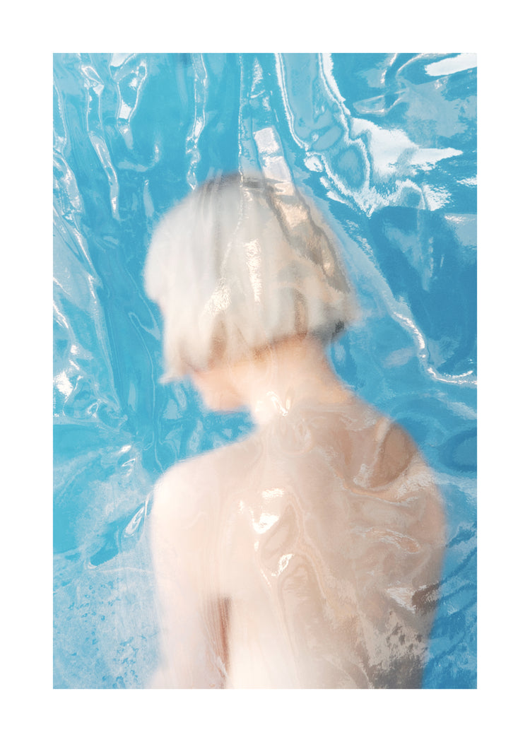 Short haired pale woman looking like a bust made from marble.