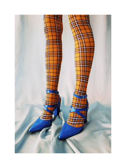 Legs wearing checkered mustard yellow stockings and high heeled blue sandals.