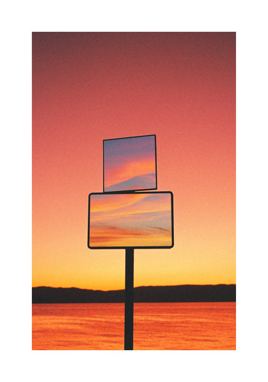 Mirrors reflecting a sunset scenery with sea and sky colored in orange and pink.