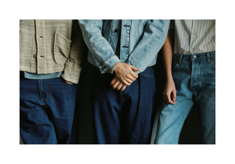 Three people dressed in different styles of denim.