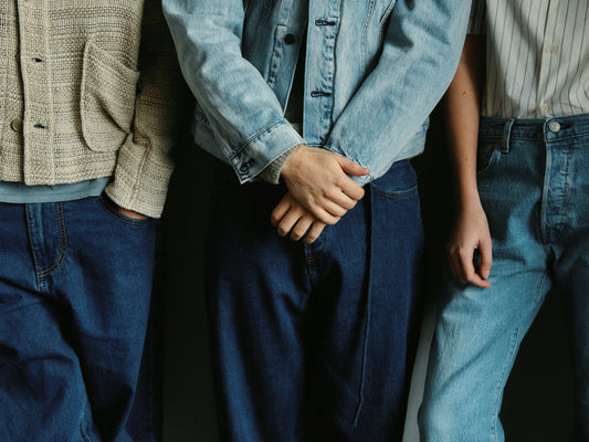 Three people dressed in different styles of denim.