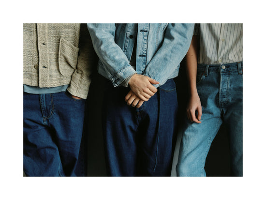 Three people dressed in different styles of denim.