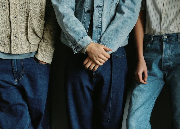 Three people dressed in different styles of denim.