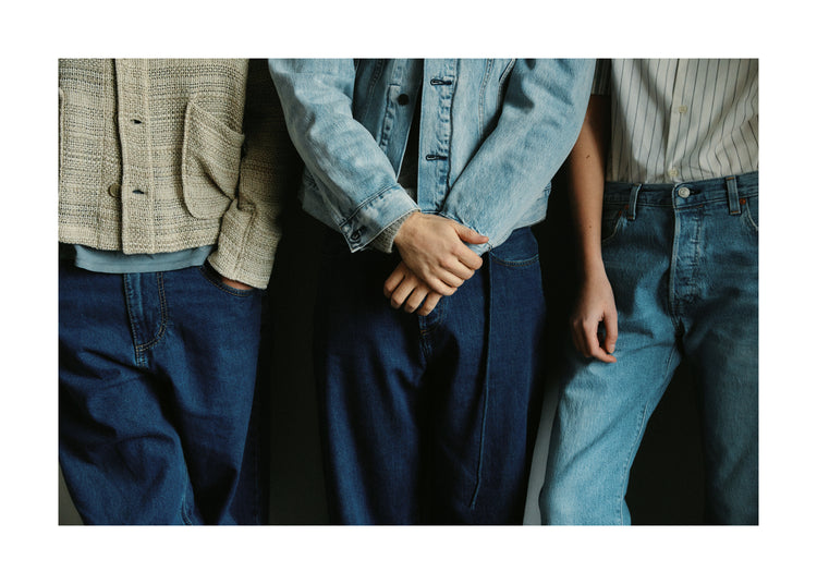 Three people dressed in different styles of denim.