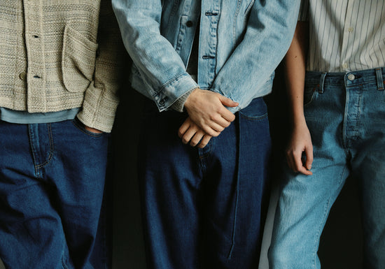 Three people dressed in different styles of denim.
