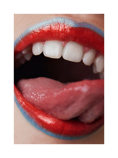 Mouth with blue lip pen and red lip stick licking its white teeth.