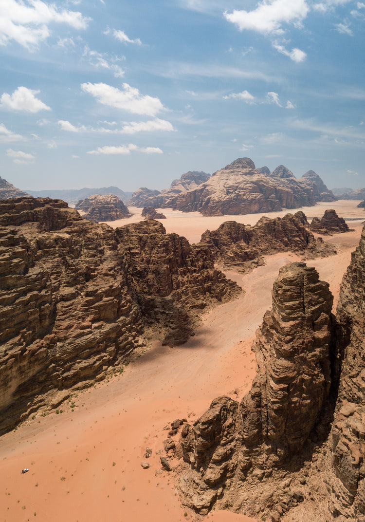 Landscape photograph with brown cliffs and rusty red dirt roads.
