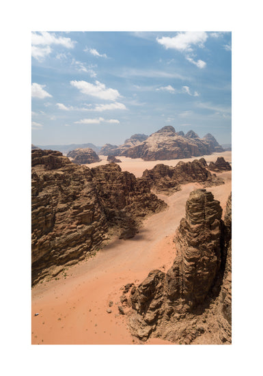 Landscape photograph with brown cliffs and rusty red dirt roads.