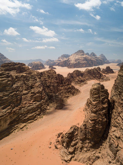 Landscape photograph with brown cliffs and rusty red dirt roads.
