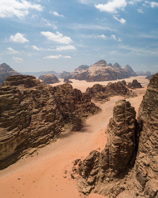 Landscape photograph with brown cliffs and rusty red dirt roads.