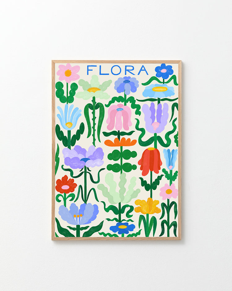 The Flora on White Poster showcases stylized blue, pink, orange, purple, yellow, and green flowers in a grid design with FLORA elegantly handwritten at the top. Its framed in simple wood against a pale background.