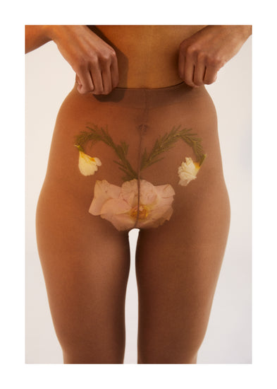 A woman in transparent stockings with a flower symbolizing her uterus.