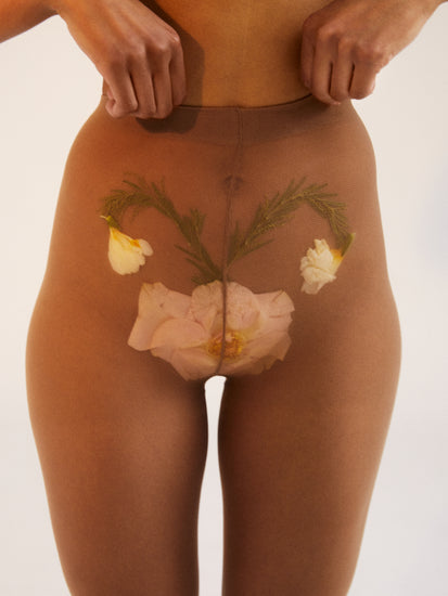 A woman in transparent stockings with a flower symbolizing her uterus.