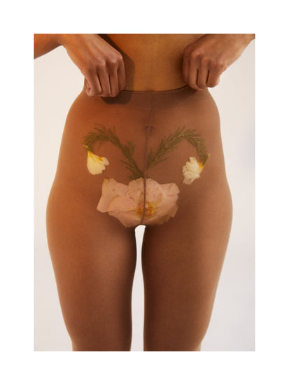 A woman in transparent stockings with a flower symbolizing her uterus.