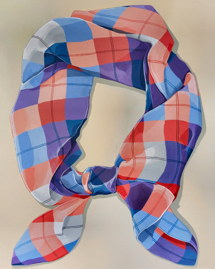 A Harlequin Knot Poster showcases a loosely knotted, brightly colored plaid scarf with shades of blue, red, purple, and white. Its smooth texture and checkered pattern reflect the artistry akin to Cat Gerkes designs.