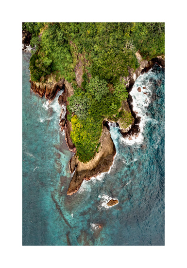 Paradise island covered in tropical jungle and surrounded by turquoise water.