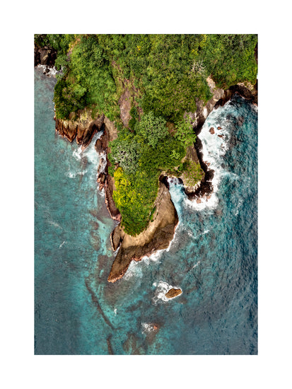 Paradise island covered in tropical jungle and surrounded by turquoise water.