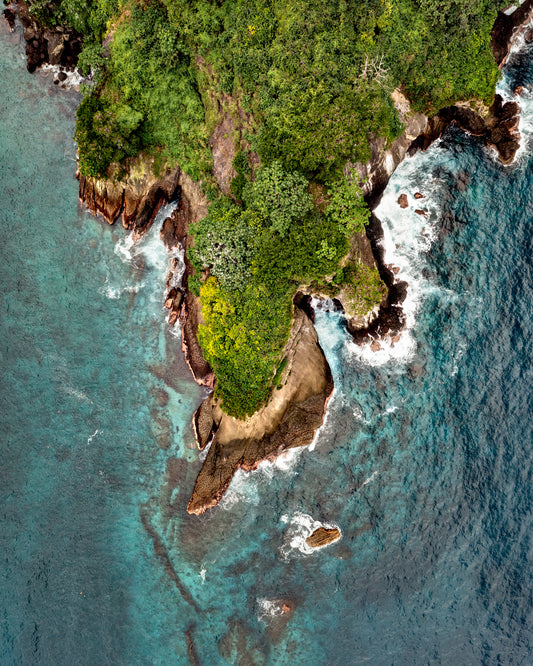 Paradise island covered in tropical jungle and surrounded by turquoise water.