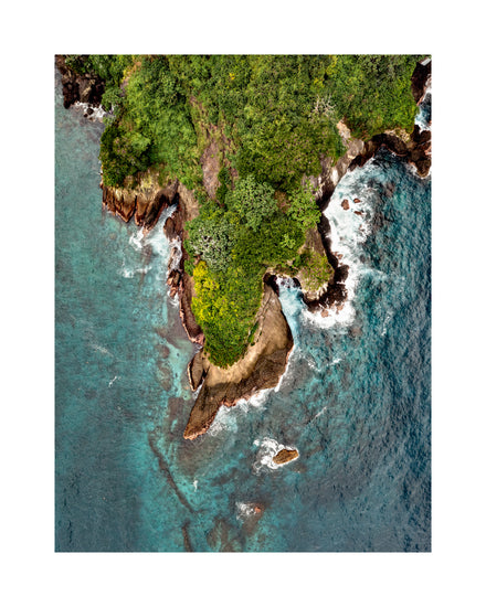 Paradise island covered in tropical jungle and surrounded by turquoise water.