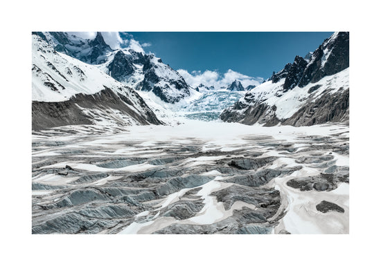 Mountain scenery with frozen grounds and snow-capped mountain peaks.