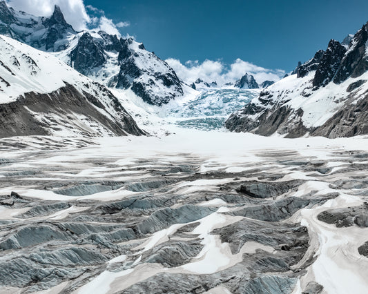 Mountain scenery with frozen grounds and snow-capped mountain peaks.