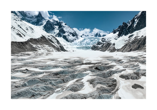 Mountain scenery with frozen grounds and snow-capped mountain peaks.