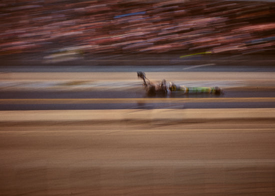 Blurry image of a cast going fast on a race car track.