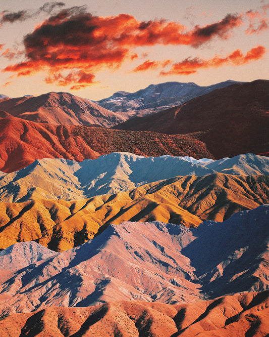 Mountain ranges in different colors creating natural lines in a barren landscape.