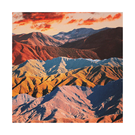 Mountain ranges in different colors creating natural lines in a barren landscape.