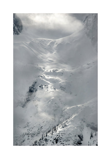 A barren mountain side covered in snow and ice.