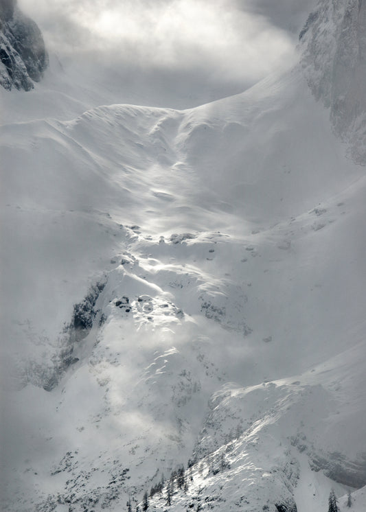A barren mountain side covered in snow and ice.