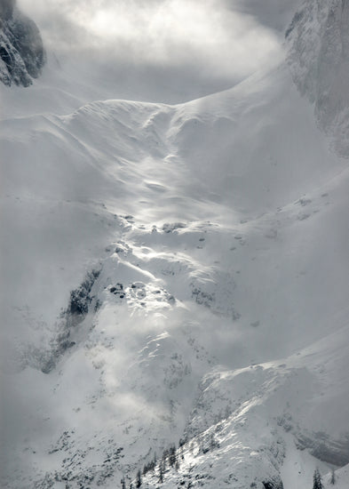 A barren mountain side covered in snow and ice.