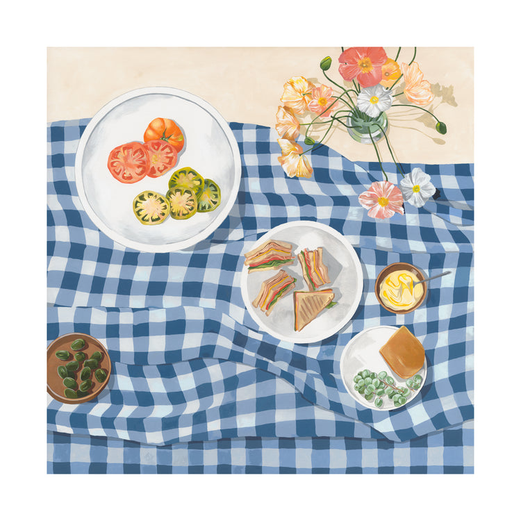 The Poppies and Picnics poster captures summertime romance with a blue checkered tablecloth displaying sliced tomatoes, sandwiches, a creamy dessert, olives, and flowers—perfect for your kitchen wall.