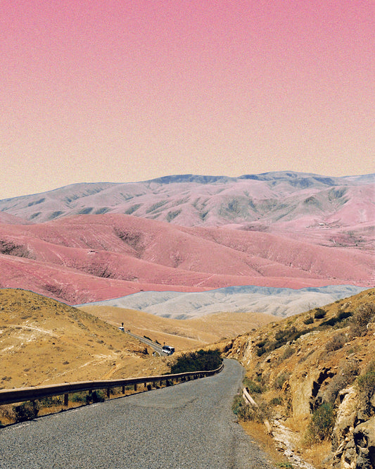 Technicolor scenic landscape with pink and purple mountains under a pink sky.