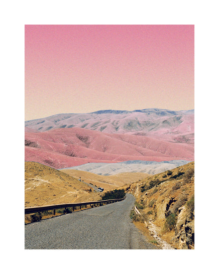 Technicolor scenic landscape with pink and purple mountains under a pink sky.