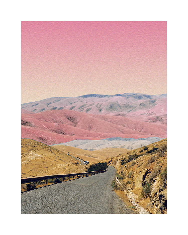 Technicolor scenic landscape with pink and purple mountains under a pink sky.