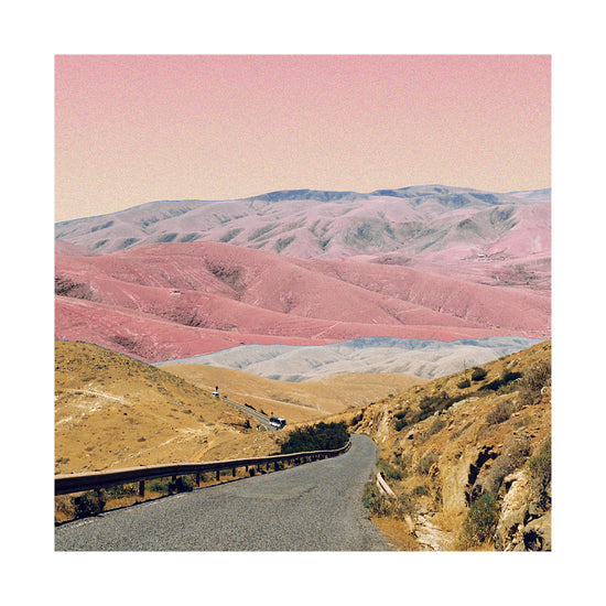 Technicolor scenic landscape with pink and purple mountains under a pink sky.