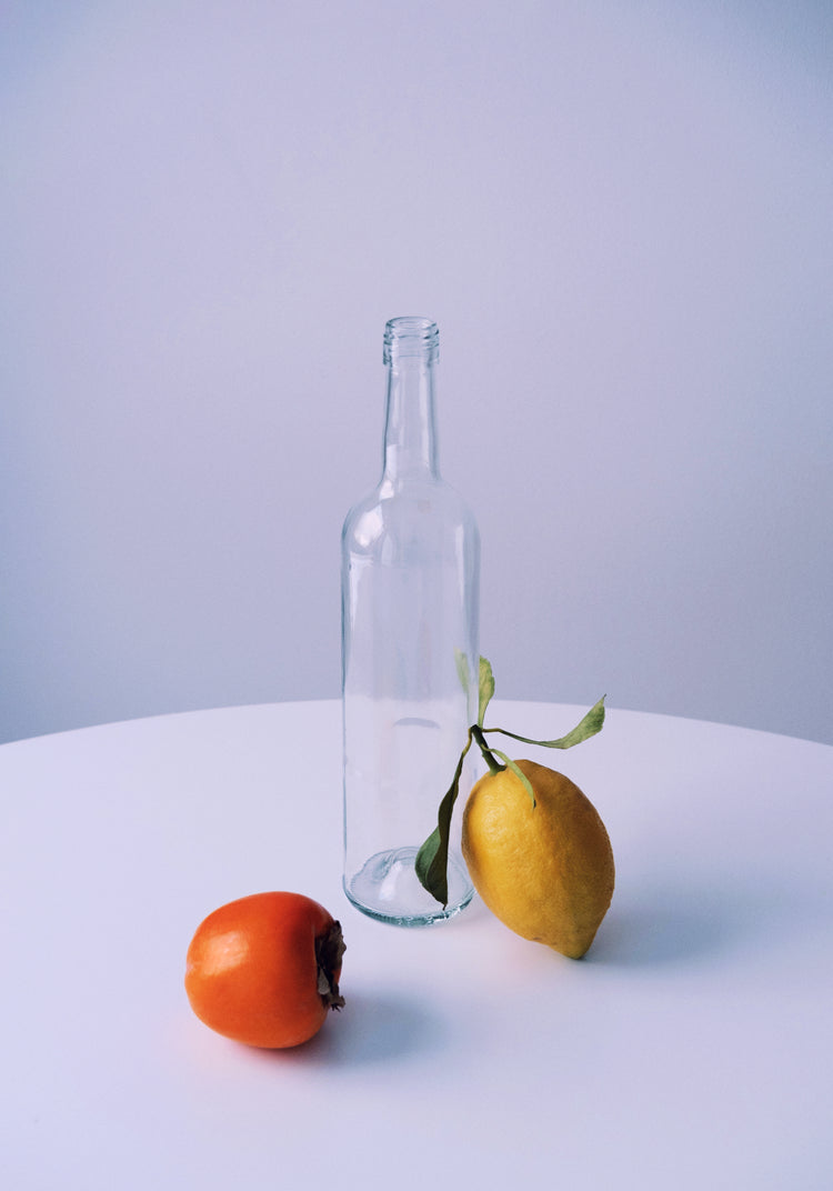 Photo of still life set up of fruits and a bottle looking like a painting.