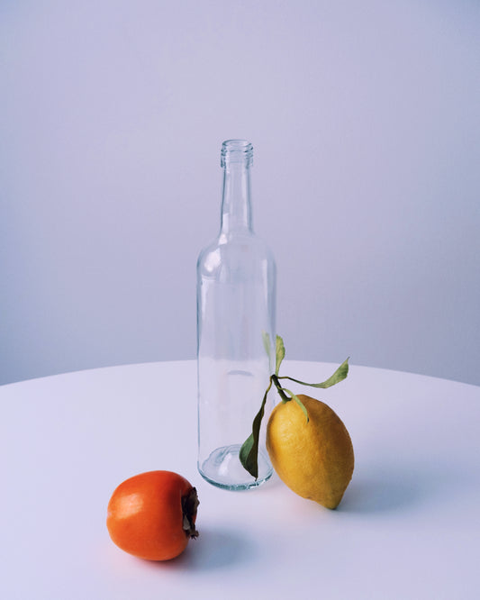Photo of still life set up of fruits and a bottle looking like a painting.