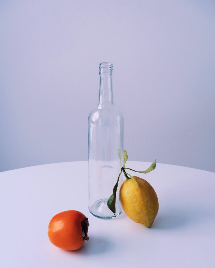 Photo of still life set up of fruits and a bottle looking like a painting.