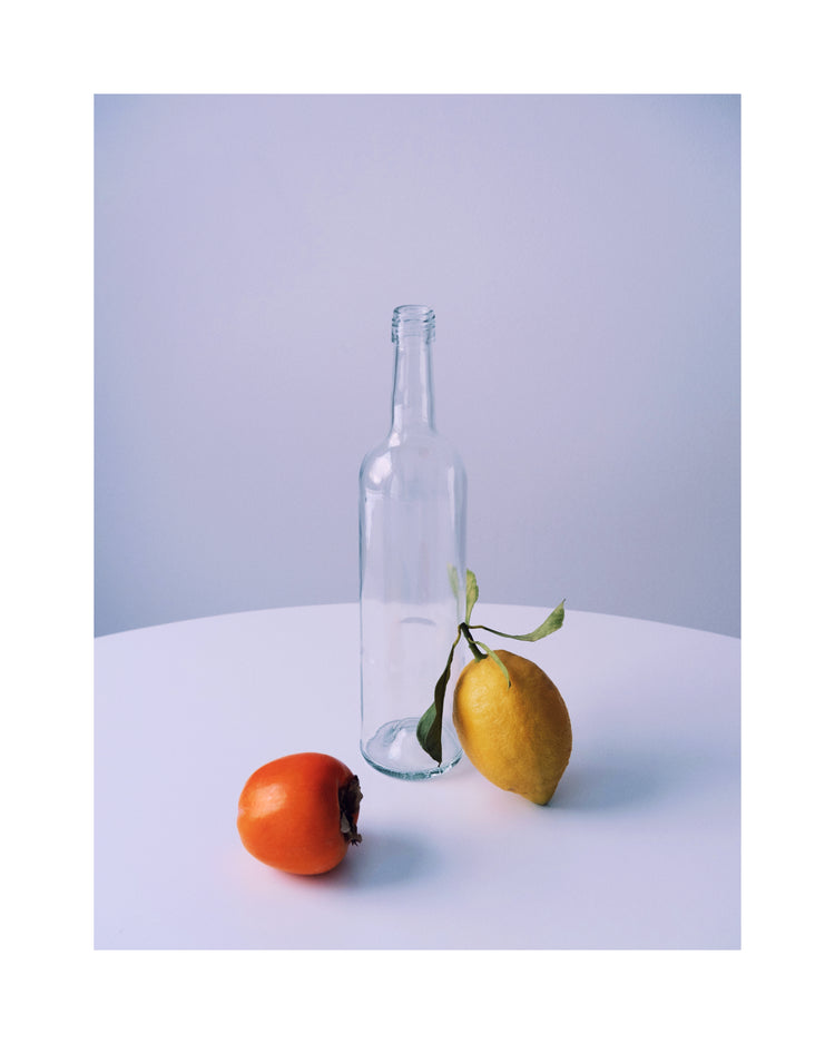 Photo of still life set up of fruits and a bottle looking like a painting.