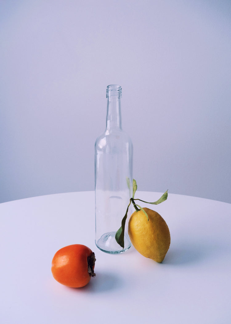 Photo of still life set up of fruits and a bottle looking like a painting.