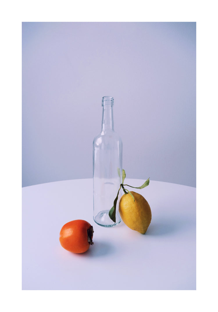 Photo of still life set up of fruits and a bottle looking like a painting.