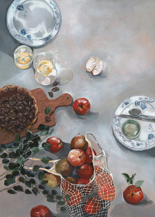 The How Do You Like These Apples Poster showcases a kitchen table adorned with vibrant red apples, a cutting board with pecans, plates, spoons, glasses of lemon slices, and a net bag of apples. A sprig of green leaves and sliced apple add the finishing touch to this warm decor.
