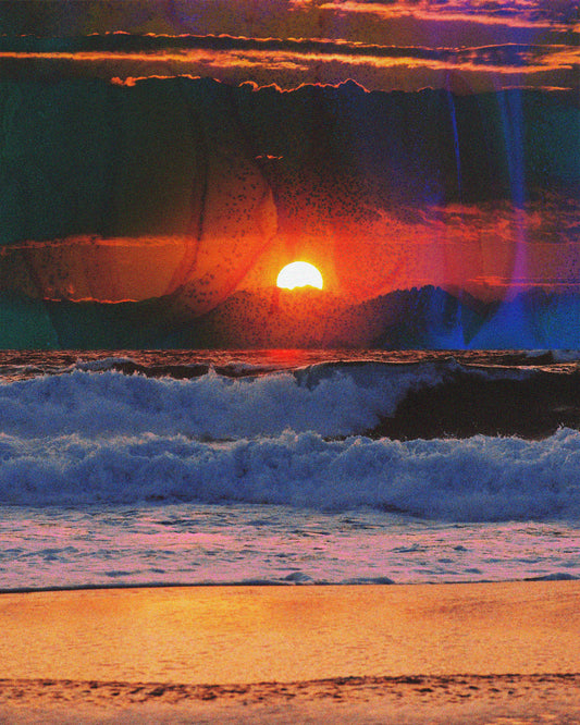 Waves crashing on the shore illuminated by a golden sunset on a cloudy sky.