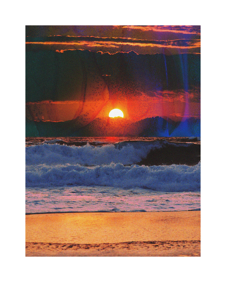 Waves crashing on the shore illuminated by a golden sunset on a cloudy sky.