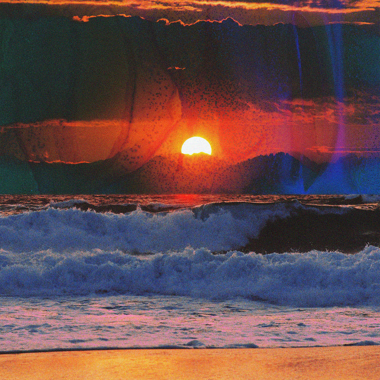 Waves crashing on the shore illuminated by a golden sunset on a cloudy sky.