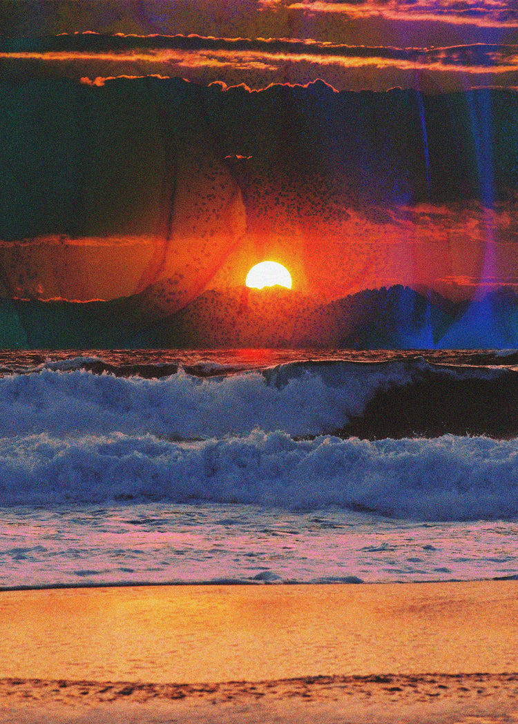 Waves crashing on the shore illuminated by a golden sunset on a cloudy sky.