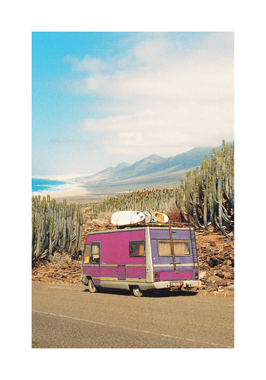 Pink trailer on the road through the dessert towards the ocean coast.
