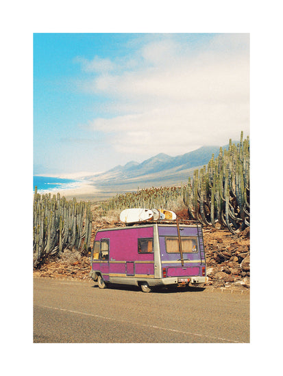 Pink trailer on the road through the dessert towards the ocean coast.
